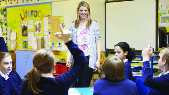 Becoming Passionate About Public Education Again teacher standing in front of students in an open classroom
