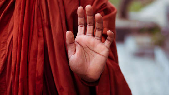 Therapeutic Touch and the Evolution of Healing Monk holding up a hand in a mudra gesture