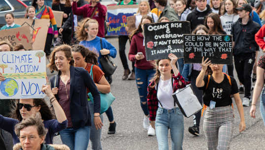 America Is More Liberal Than Its Politics Would Make You Think crowd of people marching with climate change signs and more