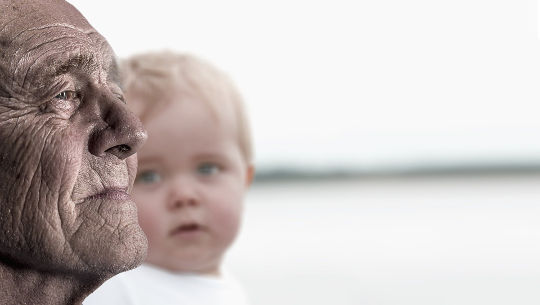 Call to Action! We Must Make A Difference the face of an old man in profile with the face of a baby looking at him