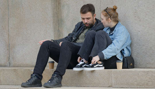 How to Build A Better Relationship Through Better Communication couple having a conversation sitting outside on steps