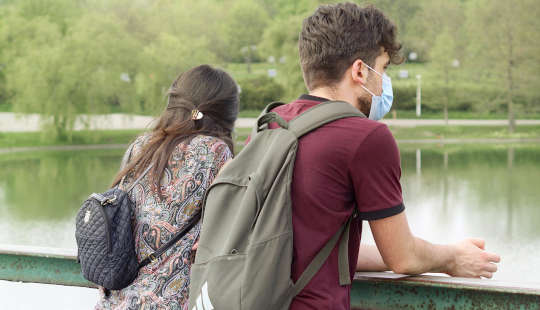 A Bridge for Healing: Dear Corona Virus... a young couple, wearing protective masks, standing on a bridge