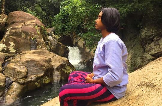 How to Meditate and Why a young man meditation outside