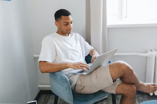 a man sitting with his legs crossed