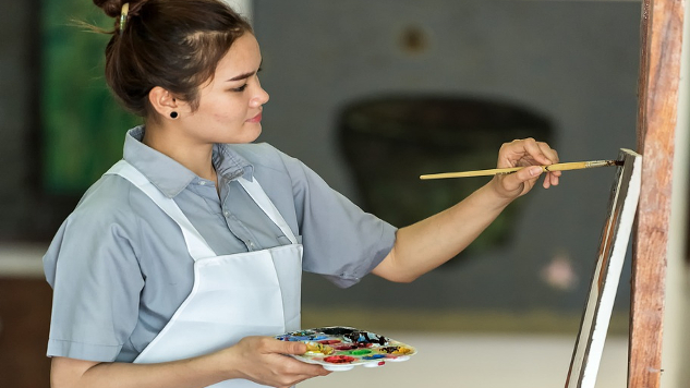 Who Am I? Reimagining Your Identity a young woman painting on an easel