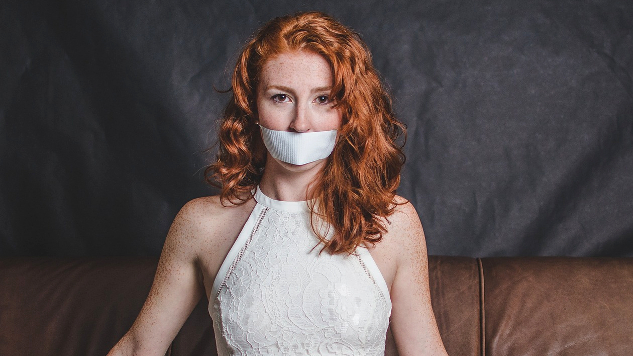 Owning and Learning to Trust My Voice woman in evening gown silenced with tape on her mouth