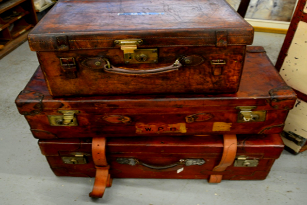 Being Displaced: Its Shocking Impact on Your Health and Well-Being three unbuckled old suitcases stacked on top of each other