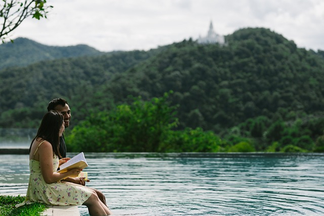 Coming Home: Welcome to the Next Chapter of Your Life a couple sitting on the edge of a lake reading a book